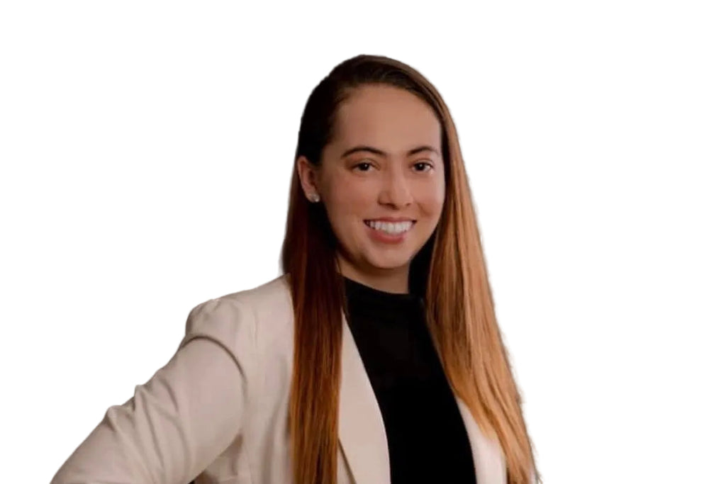 Woman in a beige blazer over a black top against a dark background